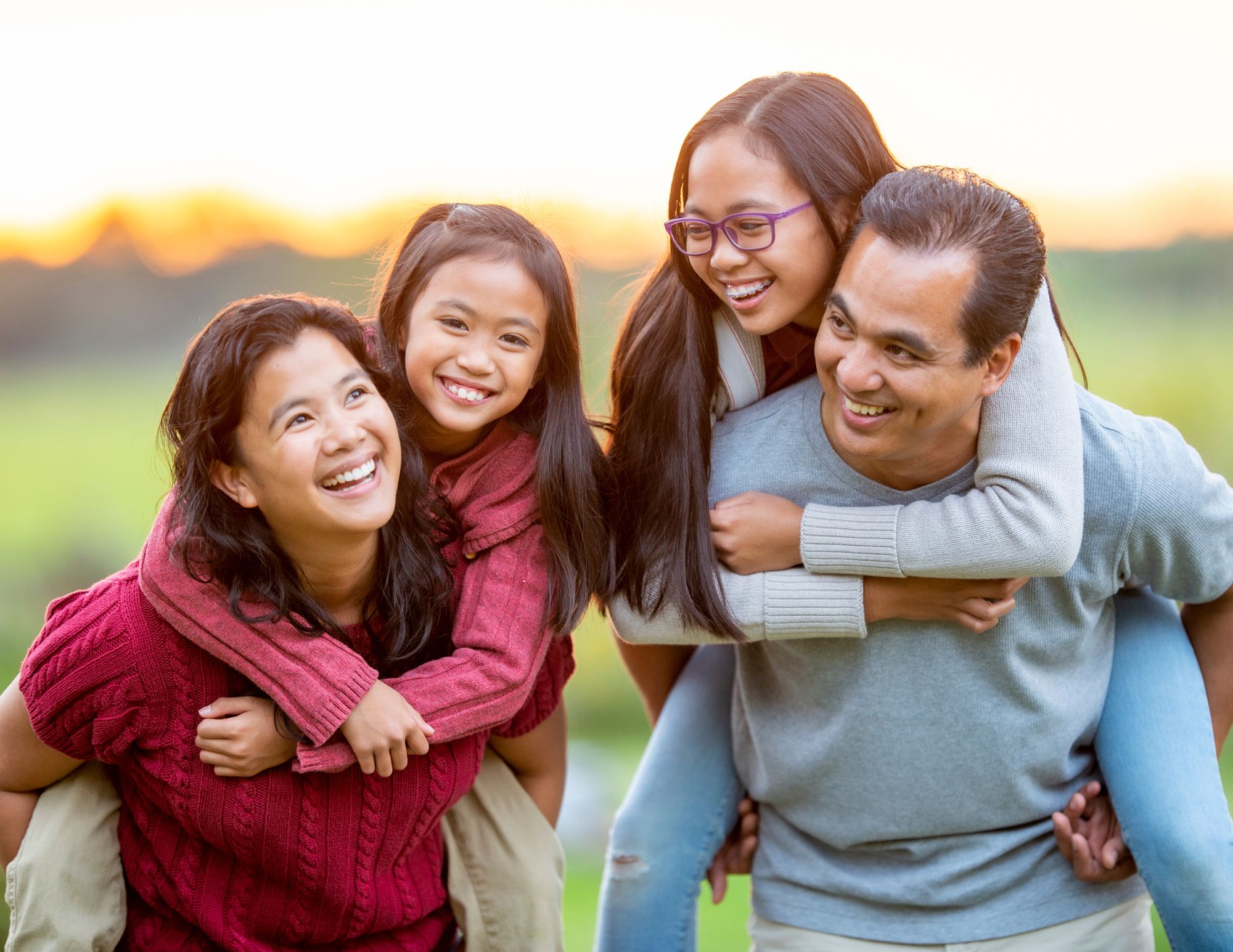Happy Asian family with kids smiling outdoors